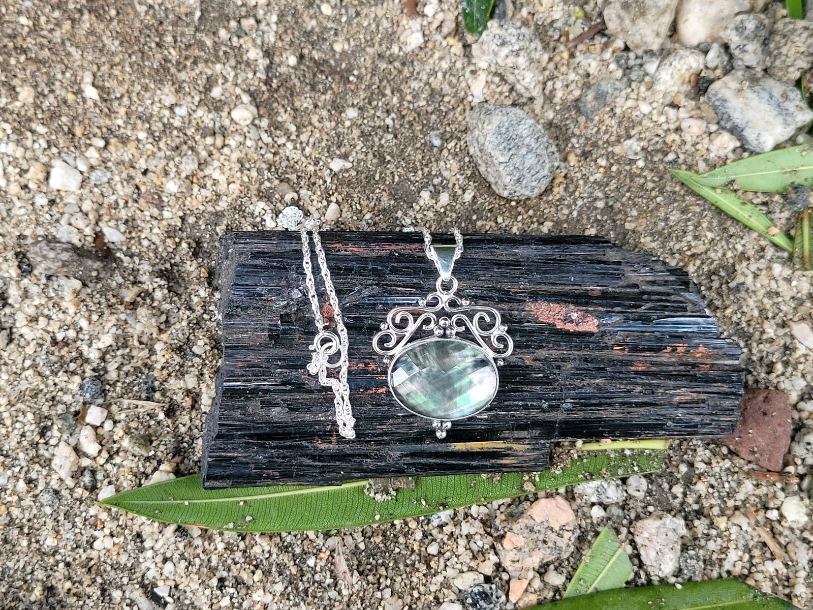 Rainbow Tahitian Mother Of Pearl With A Clear Quartz Topper