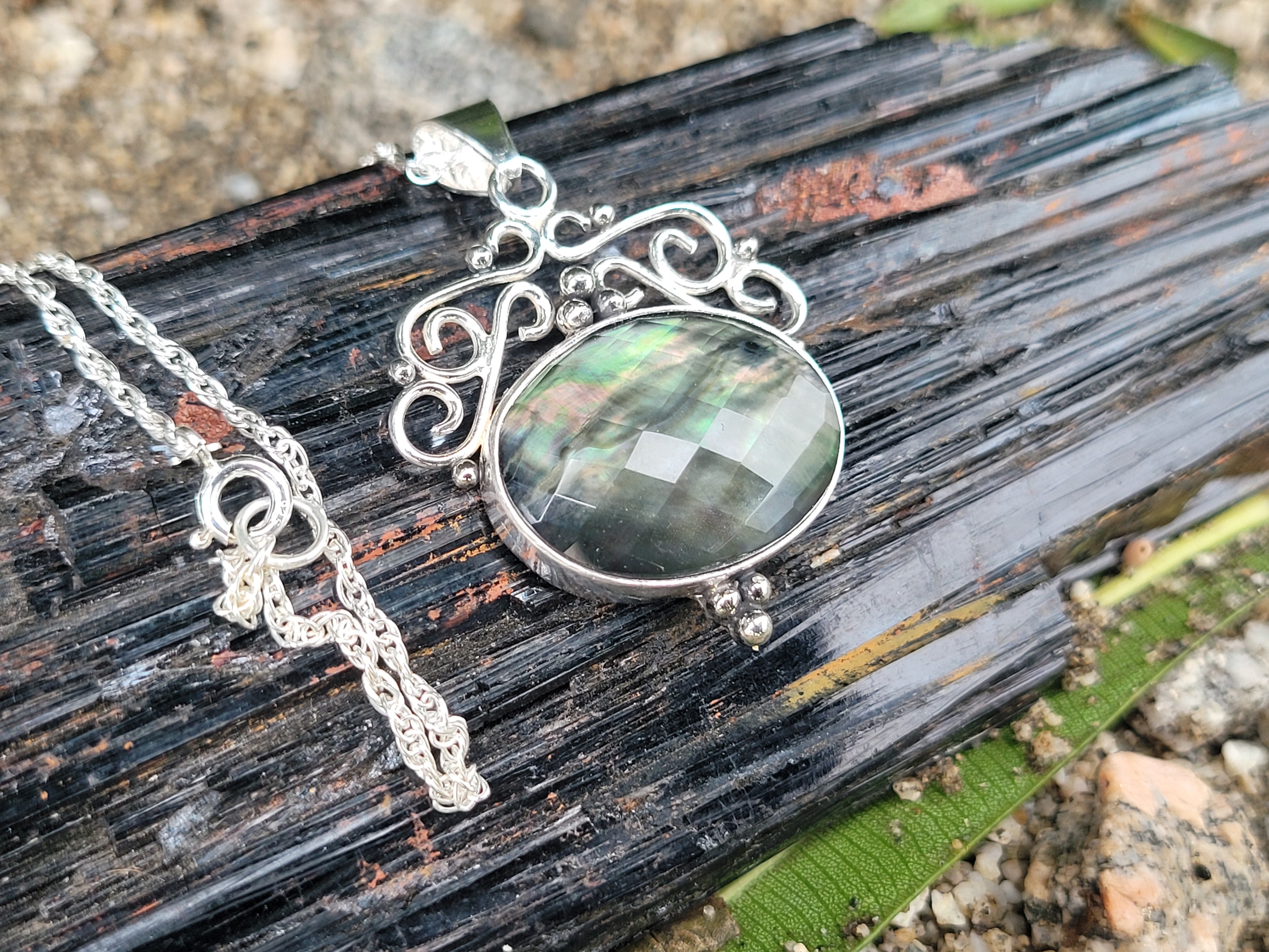 Rainbow Tahitian Mother Of Pearl With A Clear Quartz Topper