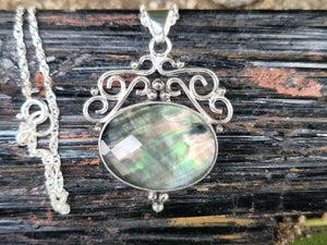 Rainbow Tahitian Mother Of Pearl With A Clear Quartz Topper